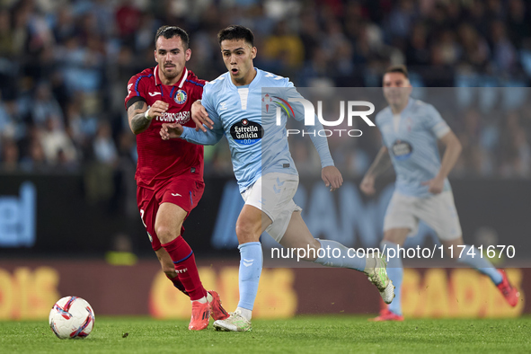 Alex Sola of Getafe CF competes for the ball with Hugo Sotelo of RC Celta de Vigo during the La Liga EA Sports match between RC Celta de Vig...