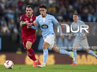 Alex Sola of Getafe CF competes for the ball with Hugo Sotelo of RC Celta de Vigo during the La Liga EA Sports match between RC Celta de Vig...