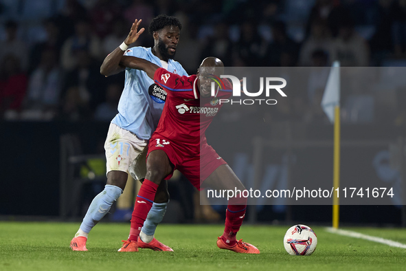 Jonathan Bamba of RC Celta de Vigo competes for the ball with Allan Nyom of Getafe CF during the La Liga EA Sports match between RC Celta de...