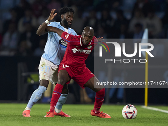 Jonathan Bamba of RC Celta de Vigo competes for the ball with Allan Nyom of Getafe CF during the La Liga EA Sports match between RC Celta de...