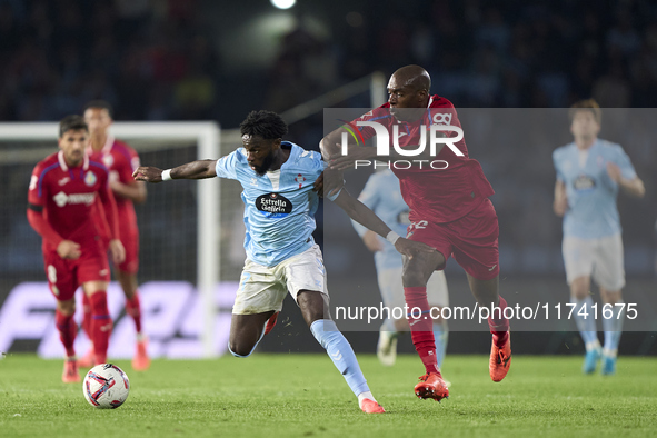 Allan Nyom of Getafe CF competes for the ball with Jonathan Bamba of RC Celta de Vigo during the La Liga EA Sports match between RC Celta de...