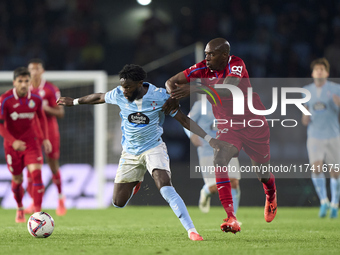 Allan Nyom of Getafe CF competes for the ball with Jonathan Bamba of RC Celta de Vigo during the La Liga EA Sports match between RC Celta de...