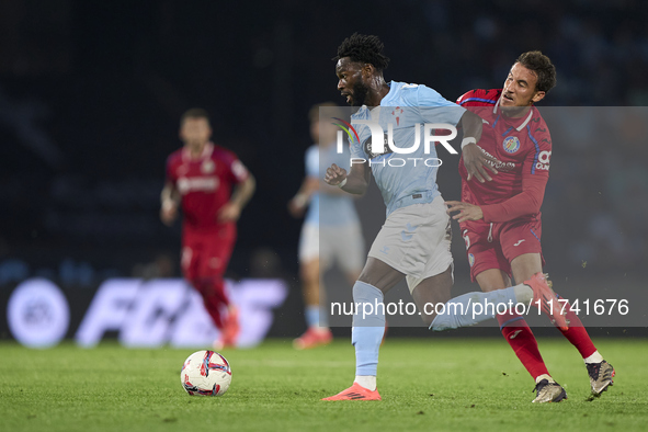 Luis Milla of Getafe CF competes for the ball with Jonathan Bamba of RC Celta de Vigo during the La Liga EA Sports match between RC Celta de...