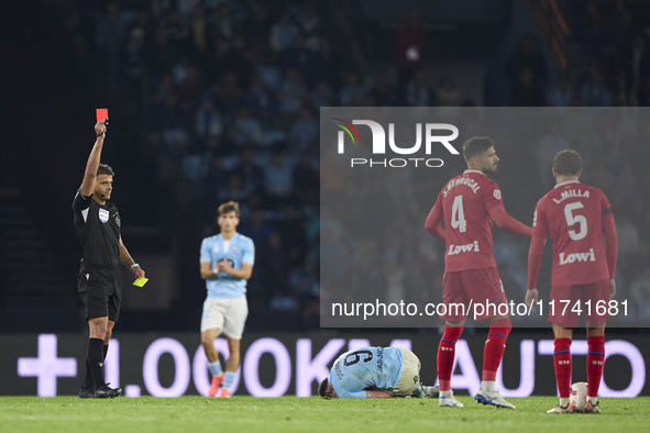 Referee Jesus Gil Manzano shows a red card to Juan Berrocal of Getafe CF during the La Liga EA Sports match between RC Celta de Vigo and Get...