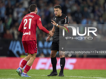 Referee Jesus Gil Manzano and Juan Iglesias of Getafe CF discuss during the La Liga EA Sports match between RC Celta de Vigo and Getafe CF a...