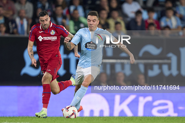 Diego Rico of Getafe CF competes for the ball with Iago Aspas of RC Celta de Vigo during the La Liga EA Sports match between RC Celta de Vig...