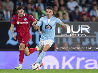 Diego Rico of Getafe CF competes for the ball with Iago Aspas of RC Celta de Vigo during the La Liga EA Sports match between RC Celta de Vig...