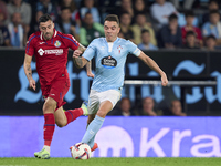 Diego Rico of Getafe CF competes for the ball with Iago Aspas of RC Celta de Vigo during the La Liga EA Sports match between RC Celta de Vig...