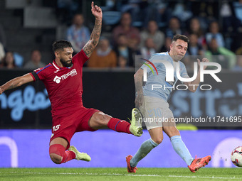 Omar Alderete of Getafe CF competes for the ball with Iago Aspas of RC Celta de Vigo during the La Liga EA Sports match between RC Celta de...