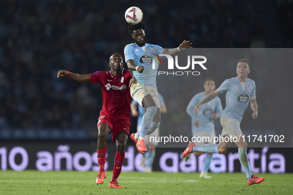 Allan Nyom of Getafe CF competes for the ball with Jonathan Bamba of RC Celta de Vigo during the La Liga EA Sports match between RC Celta de...