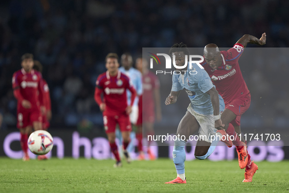 Allan Nyom of Getafe CF competes for the ball with Jonathan Bamba of RC Celta de Vigo during the La Liga EA Sports match between RC Celta de...