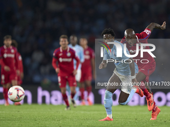 Allan Nyom of Getafe CF competes for the ball with Jonathan Bamba of RC Celta de Vigo during the La Liga EA Sports match between RC Celta de...