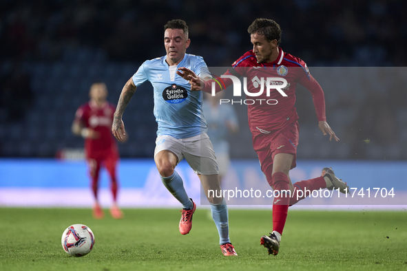 Luis Milla of Getafe CF competes for the ball with Iago Aspas of RC Celta de Vigo during the La Liga EA Sports match between RC Celta de Vig...