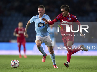 Luis Milla of Getafe CF competes for the ball with Iago Aspas of RC Celta de Vigo during the La Liga EA Sports match between RC Celta de Vig...