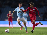 Luis Milla of Getafe CF competes for the ball with Iago Aspas of RC Celta de Vigo during the La Liga EA Sports match between RC Celta de Vig...