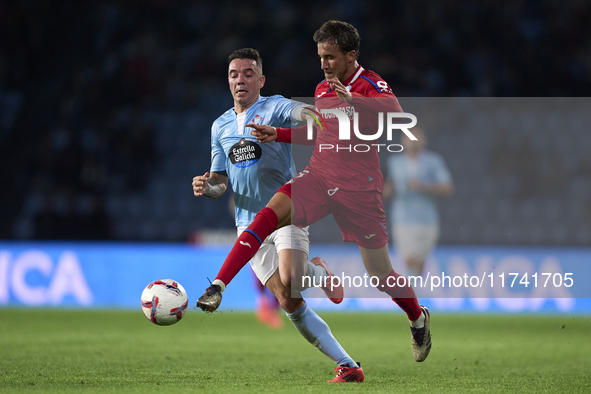 Iago Aspas of RC Celta de Vigo competes for the ball with Luis Milla of Getafe CF during the La Liga EA Sports match between RC Celta de Vig...