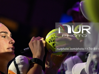 RIYADH, SAUDI ARABIA - NOVEMBER 04: Aryna Sabalenka of Belarus signs autographs for her fans after her match against Jasmine Paolini of Ital...