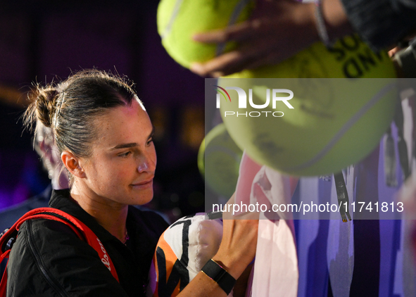 RIYADH, SAUDI ARABIA - NOVEMBER 04: Aryna Sabalenka of Belarus signs autographs for her fans after her match against Jasmine Paolini of Ital...