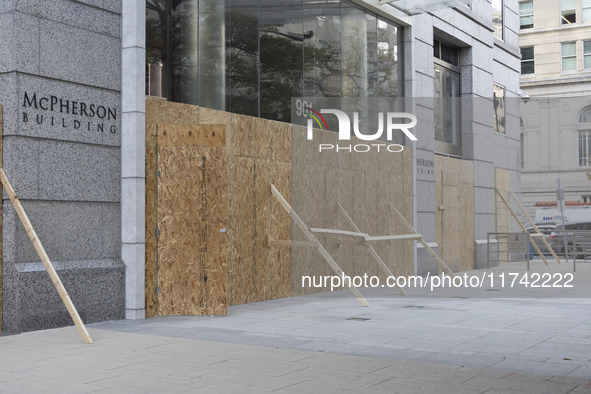 A store is boarded up with plywood fencing in Washington DC, United States, on November 4, 2024, ahead of the Presidential Election. 