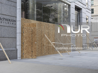 A store is boarded up with plywood fencing in Washington DC, United States, on November 4, 2024, ahead of the Presidential Election. (