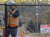 Workers erect security fences surrounding the construction site for the 2025 Presidential Inaugural Parade Reviewing Stand in Lafayette Squa...