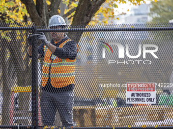 Workers erect security fences surrounding the construction site for the 2025 Presidential Inaugural Parade Reviewing Stand in Lafayette Squa...