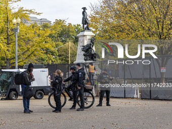 Workers erect security fences surrounding the construction site for the 2025 Presidential Inaugural Parade Reviewing Stand in Lafayette Squa...