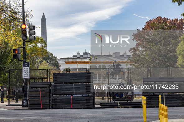 Workers erect security fences surrounding the construction site for the 2025 Presidential Inaugural Parade Reviewing Stand in Lafayette Squa...