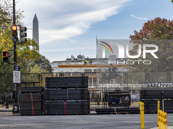 Workers erect security fences surrounding the construction site for the 2025 Presidential Inaugural Parade Reviewing Stand in Lafayette Squa...