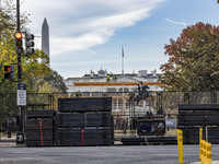 Workers erect security fences surrounding the construction site for the 2025 Presidential Inaugural Parade Reviewing Stand in Lafayette Squa...