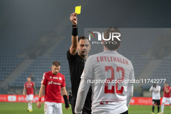 Referee Piotr Rzucidlo shows a yellow card to Julius Ertlthaler during the game between Wisla Krakow and GKS Tychy in Krakow, Poland, on Nov...