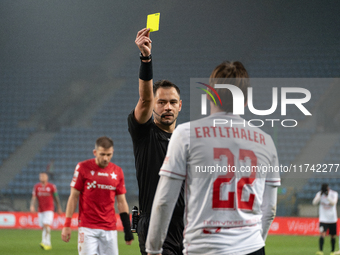 Referee Piotr Rzucidlo shows a yellow card to Julius Ertlthaler during the game between Wisla Krakow and GKS Tychy in Krakow, Poland, on Nov...