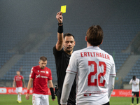 Referee Piotr Rzucidlo shows a yellow card to Julius Ertlthaler during the game between Wisla Krakow and GKS Tychy in Krakow, Poland, on Nov...