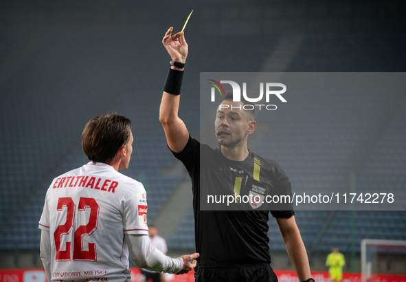 Referee Piotr Rzucidlo shows a yellow card to Julius Ertlthaler during the game between Wisla Krakow and GKS Tychy in Krakow, Poland, on Nov...