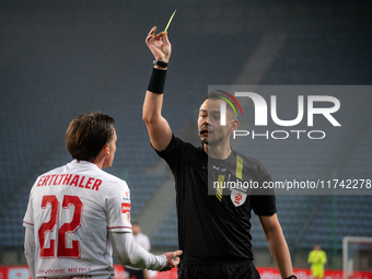 Referee Piotr Rzucidlo shows a yellow card to Julius Ertlthaler during the game between Wisla Krakow and GKS Tychy in Krakow, Poland, on Nov...