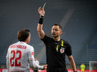 Referee Piotr Rzucidlo shows a yellow card to Julius Ertlthaler during the game between Wisla Krakow and GKS Tychy in Krakow, Poland, on Nov...