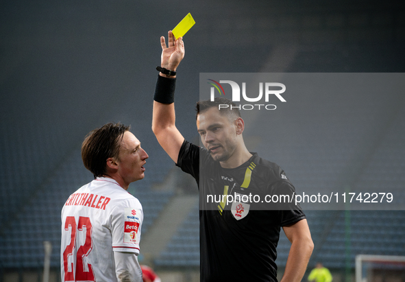 Referee Piotr Rzucidlo shows a yellow card to Julius Ertlthaler during the game between Wisla Krakow and GKS Tychy in Krakow, Poland, on Nov...