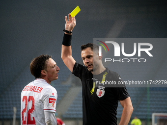 Referee Piotr Rzucidlo shows a yellow card to Julius Ertlthaler during the game between Wisla Krakow and GKS Tychy in Krakow, Poland, on Nov...