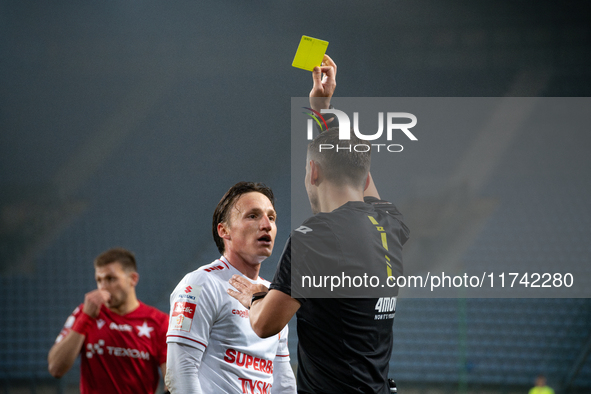 Referee Piotr Rzucidlo shows a yellow card to Julius Ertlthaler during the game between Wisla Krakow and GKS Tychy in Krakow, Poland, on Nov...