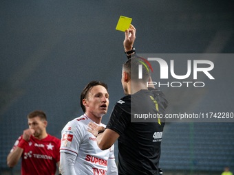 Referee Piotr Rzucidlo shows a yellow card to Julius Ertlthaler during the game between Wisla Krakow and GKS Tychy in Krakow, Poland, on Nov...