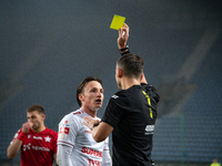 Referee Piotr Rzucidlo shows a yellow card to Julius Ertlthaler during the game between Wisla Krakow and GKS Tychy in Krakow, Poland, on Nov...