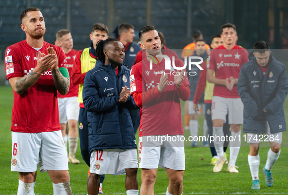 Alan Uryga, James Igbekeme, and Angel Rodado stand after the game between Wisla Krakow and GKS Tychy in Krakow, Poland, on November 4, 2024....