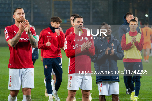 Alan Uryga, James Igbekeme, and Angel Rodado stand after the game between Wisla Krakow and GKS Tychy in Krakow, Poland, on November 4, 2024....