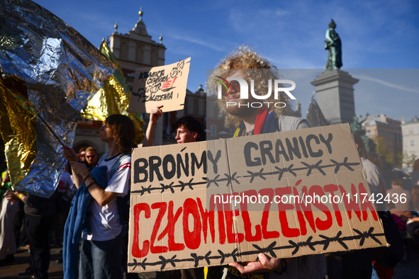 People attend a demonstration against the Polish government's plans to suspend the right to asylum for refugees illegally crossing the Polis...