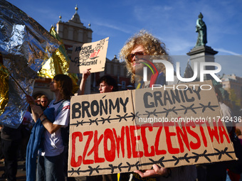 People attend a demonstration against the Polish government's plans to suspend the right to asylum for refugees illegally crossing the Polis...