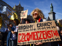 People attend a demonstration against the Polish government's plans to suspend the right to asylum for refugees illegally crossing the Polis...