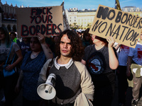 People attend a demonstration against the Polish government's plans to suspend the right to asylum for refugees illegally crossing the Polis...