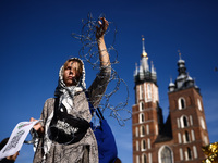 A woman holds barbed wire while attending a demonstration against the Polish government's plans to suspend the right to asylum for refugees...