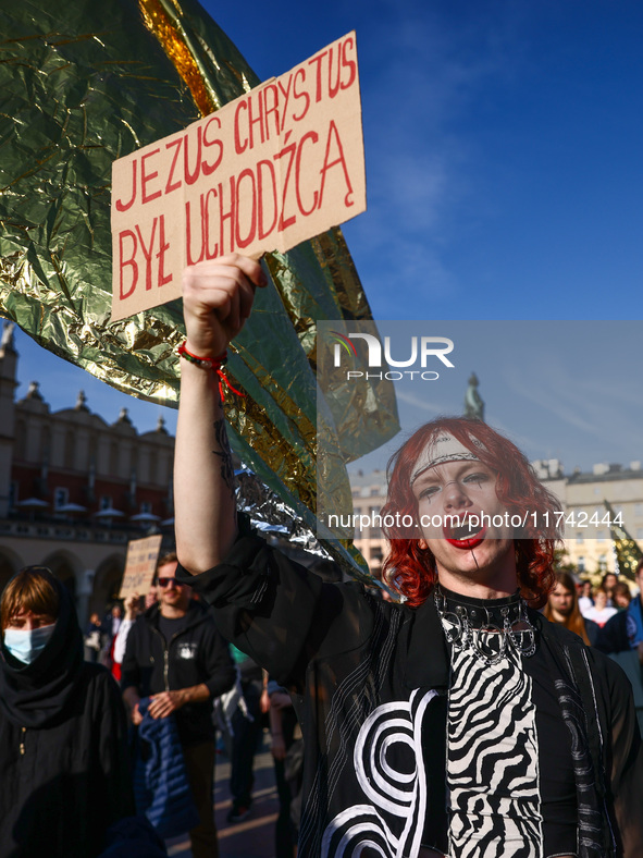 A person holds a banner reading 'Jesus Christ was a refugee' while attending a demonstration against the Polish government's plans to suspen...