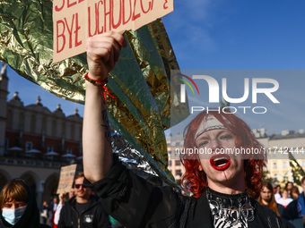 A person holds a banner reading 'Jesus Christ was a refugee' while attending a demonstration against the Polish government's plans to suspen...